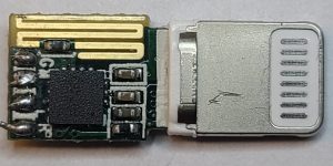 Lightning connector board with gold antenna traces and a black controller package