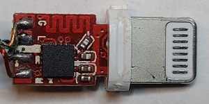 Teardown of a counterfeit Lightning connector exposing its internal circuit board